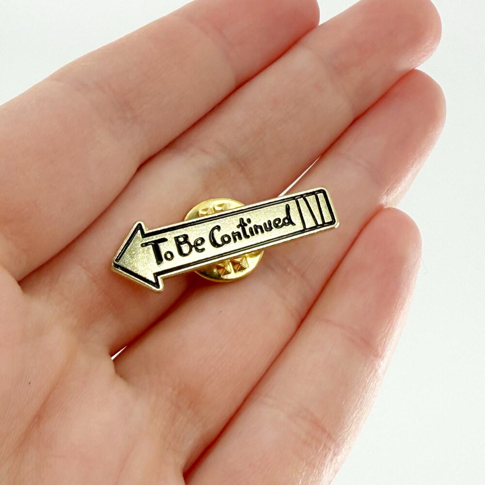 To Be Continued Gold Arrow Enamel Pin